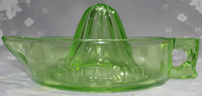 Side view of a green uranium curved handle glass Sunkist juicer