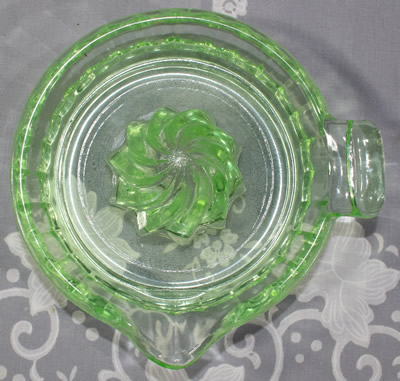 Top view of a clockwise spiral 1 piece apple green glass juicer