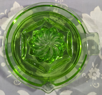 Top view of a Anchor Hocking Glass Company green glass tab handle spiral juicer