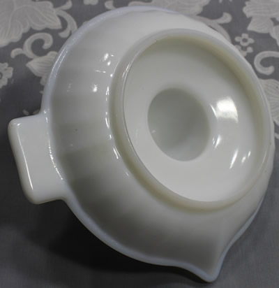 Bottom view of a white milk glass 29 panels saucer juicer