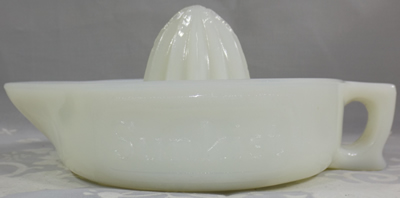 Side view of an Indiana Glass Company blocked Sunkist white milk glass juicer