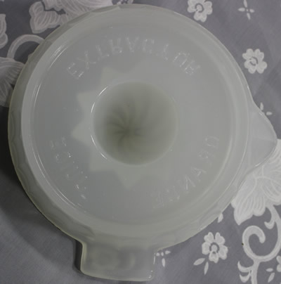 The embossed on base of a U.S. Glass Co. Clambroth (Translucent white) juicer