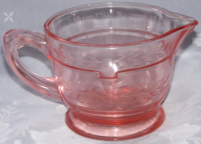 Showing the etching on a U.S. Glass pink glass juicer jug