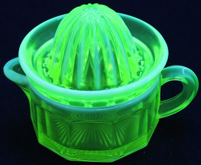 A frosted trim yellow Edna Barnes cup juicer under UV light