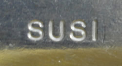 The brand name on an aluminium squeezer juicer with yellow plastic insert