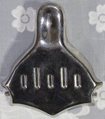 Back view of a Japanese inscribed stainless steel lemon wedge squeezer