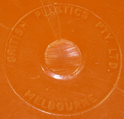 Embossed brand on the base of an orange jug and white plastic juicer