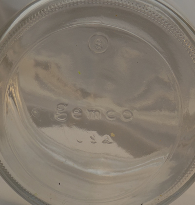 Branded glass base of a yellow Gemco 2 piece juicer