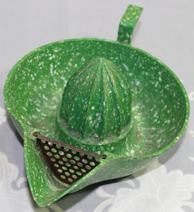 Showing the strainer on the green and white mottled bakelite strainer juicer