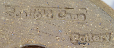 The potter's mark on a tan Scaffold Cane Pottery 'mushroom' juicer