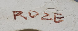 The potter's signature on a yellow plaster juicer