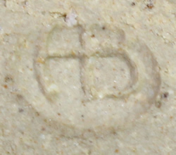 Potter's mark on brown and unglazed bowl like pottery juicer