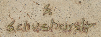 The potter's mark on a specked brown on light brown 2 loop pottery bowl juicer