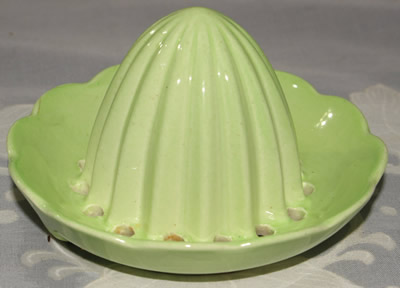 A pale green Carlton Ware juicer top