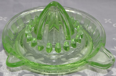 A Crown Crystal Glass Type 1 green glass juicer