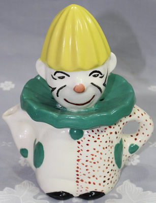 Green and yellow on white ceramic class clown juicer