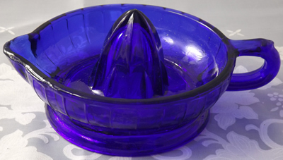 A modern jug like cobalt blue glass juicer