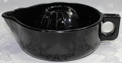 A black McKee Glass Co. 'grapefruit' juicer