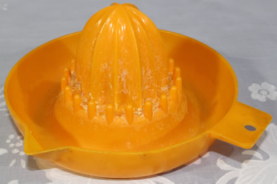 Orange plastic saucer juicer